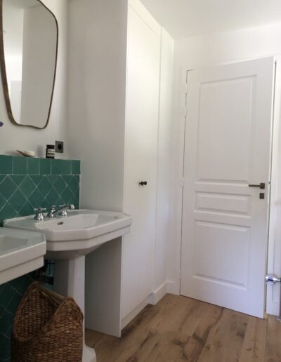 Salle de bains avec 2 vasques, zelliges muraux et miroir.